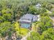 Aerial view of the home's screened pool, yard, and surrounding lush landscape at 6325 Palmas Bay Cir, Port Orange, FL 32127