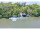 Aerial view of the dock with waterfront access and surrounding trees at 6325 Palmas Bay Cir, Port Orange, FL 32127