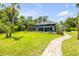 This home has a large green backyard and a screened in in-ground pool at 6325 Palmas Bay Cir, Port Orange, FL 32127