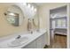 A bright bathroom with double sinks and a view into the bedroom at 6325 Palmas Bay Cir, Port Orange, FL 32127