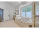 Bright bathroom includes tub, shower with glass door, and vanity area for maximum accessibility at 6325 Palmas Bay Cir, Port Orange, FL 32127