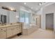 Bright bathroom with soaking tub, glass shower, and large vanity perfect for relaxation at 6325 Palmas Bay Cir, Port Orange, FL 32127