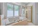 Bright bathroom includes tub, shower with glass door, and vanity area for maximum accessibility at 6325 Palmas Bay Cir, Port Orange, FL 32127