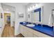 A well-lit bathroom with a blue countertop, white cabinets, and a sink at 6325 Palmas Bay Cir, Port Orange, FL 32127