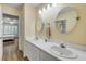 Bright bathroom with double sinks, vanity, and two round mirrors at 6325 Palmas Bay Cir, Port Orange, FL 32127