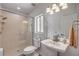 Clean bathroom with walk-in shower, glass door, and pedestal sink for a modern look at 6325 Palmas Bay Cir, Port Orange, FL 32127