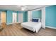 A light and airy bedroom with aqua walls, a Murphy bed, and a ceiling fan at 6325 Palmas Bay Cir, Port Orange, FL 32127