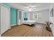 A light and airy bedroom with aqua walls, a Murphy bed, and a ceiling fan at 6325 Palmas Bay Cir, Port Orange, FL 32127