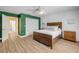 A bedroom featuring wood-look flooring, a rustic bed frame, and white trim at 6325 Palmas Bay Cir, Port Orange, FL 32127