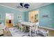 Dining room with views to the living room and stairway with light blue walls and wood-look tile floors at 6325 Palmas Bay Cir, Port Orange, FL 32127