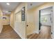 Hallway leading to a bright bedroom with plantation shutters at 6325 Palmas Bay Cir, Port Orange, FL 32127
