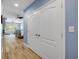 Hallway leading to a Primary bedroom with a decorative ceiling fan and wood-look flooring at 6325 Palmas Bay Cir, Port Orange, FL 32127