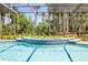 In ground tiled hot tub with waterfall feature surrounded by lush trees at 6325 Palmas Bay Cir, Port Orange, FL 32127