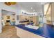 Open kitchen area featuring custom cabinets, blue countertops and views of the living room and outdoor space at 6325 Palmas Bay Cir, Port Orange, FL 32127