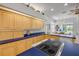 Kitchen featuring custom wood cabinets, blue countertops with breakfast nook offering scenic pool and backyard views at 6325 Palmas Bay Cir, Port Orange, FL 32127