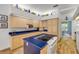 Bright kitchen featuring blue countertops, light wood cabinets, and a modern electric cooktop at 6325 Palmas Bay Cir, Port Orange, FL 32127