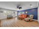 A cozy living room featuring nautical decorations and an orange couch at 6325 Palmas Bay Cir, Port Orange, FL 32127