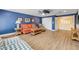 A cozy living room featuring nautical decorations and an orange couch at 6325 Palmas Bay Cir, Port Orange, FL 32127