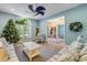 Bright living room with striped sofas, decorative fan, and a view into the entryway and dining area at 6325 Palmas Bay Cir, Port Orange, FL 32127