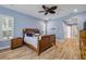 Bright bedroom with wood-look flooring, comfortable bed, and ample natural light at 6325 Palmas Bay Cir, Port Orange, FL 32127