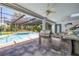 This is an outdoor kitchen featuring a built in grill and a covered pool at 6325 Palmas Bay Cir, Port Orange, FL 32127