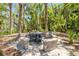 Stone patio with table and chairs set among palm trees at 6325 Palmas Bay Cir, Port Orange, FL 32127
