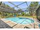 This beautiful in-ground pool and spa is fully enclosed with a screen at 6325 Palmas Bay Cir, Port Orange, FL 32127