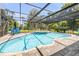 This beautiful in-ground pool is surrounded by tropical trees at 6325 Palmas Bay Cir, Port Orange, FL 32127