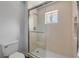 A modern shower with white tiling and a glass door at 6325 Palmas Bay Cir, Port Orange, FL 32127