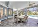 Sunroom with tile floors, dining area, outdoor kitchen, and view of the pool at 6325 Palmas Bay Cir, Port Orange, FL 32127