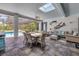 Bright sunroom featuring an outdoor kitchen, dining, and living area with access to the pool at 6325 Palmas Bay Cir, Port Orange, FL 32127