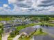 Community aerial view of homes around lake at 6804 Forkmead Ln, Port Orange, FL 32128
