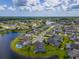 Stunning aerial view of a lakeside community featuring beautiful homes, serene waters, and lush green landscapes at 6804 Forkmead Ln, Port Orange, FL 32128