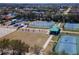A high view of the community playground, showcasing tennis courts and a play area in a Gathering-friendly environment at 6804 Forkmead Ln, Port Orange, FL 32128