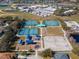 Aerial view of a community playground featuring a park with tennis and basketball courts at 6804 Forkmead Ln, Port Orange, FL 32128
