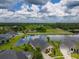 A beautiful aerial view of a well-maintained home next to a peaceful lake, showcasing the tranquil backyard setting at 6804 Forkmead Ln, Port Orange, FL 32128