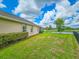 Large backyard with view of pond and partial view of the back of house at 6804 Forkmead Ln, Port Orange, FL 32128