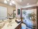 Cozy bathroom with a palm tree shower curtain and a dark wood vanity at 6804 Forkmead Ln, Port Orange, FL 32128