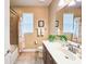 Well-lit bathroom featuring a shower-tub combo, dark cabinets, and a large mirror at 6804 Forkmead Ln, Port Orange, FL 32128
