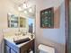 Bathroom featuring a framed fish display, with neutral-toned walls and vanity at 6804 Forkmead Ln, Port Orange, FL 32128
