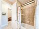 Bathroom showcasing a tiled shower and separate tub, next to a door with a view to another room at 6804 Forkmead Ln, Port Orange, FL 32128