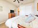 Comfortable bedroom featuring a ceiling fan, dresser, and closet, creating a cozy and functional space at 6804 Forkmead Ln, Port Orange, FL 32128