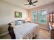 Bedroom featuring a comfortable bed, a painting, and windows with natural light at 6804 Forkmead Ln, Port Orange, FL 32128