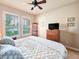 Comfortable bedroom featuring shuttered windows, a ceiling fan, and nice furnishings at 6804 Forkmead Ln, Port Orange, FL 32128