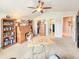 Expansive bonus room with workspace, bookcases, and multiple entryways, offering versatility and convenience at 6804 Forkmead Ln, Port Orange, FL 32128