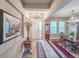 Inviting entryway with a view into an elegant dining area, adorned with a striking chandelier at 6804 Forkmead Ln, Port Orange, FL 32128
