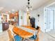Charming dining area with a wooden table, pendant lighting, and easy access to the kitchen at 6804 Forkmead Ln, Port Orange, FL 32128