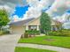 Well-maintained one-story home boasting a manicured lawn, an attached garage, and a classic façade at 6804 Forkmead Ln, Port Orange, FL 32128
