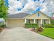 Well-maintained one-story home boasting a manicured lawn, an attached garage, and a classic façade at 6804 Forkmead Ln, Port Orange, FL 32128