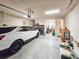 Large garage with white car, shelving, storage, and access to the home at 6804 Forkmead Ln, Port Orange, FL 32128